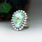 3/4 view facing left, pear shaped sonoran gold turquoise statement ring, the stone is light turquoise with darker turquoise and gold veining
